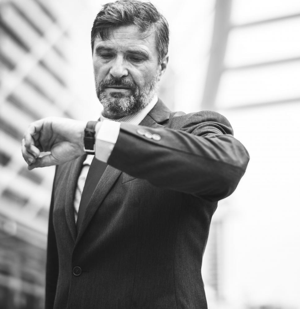 a-bearded-businessman-looks-at-time--black-and-white